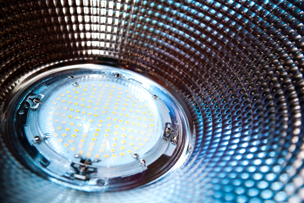 Close-up of a high-powered LED chip in a metallic reflector for energy-efficient lighting.