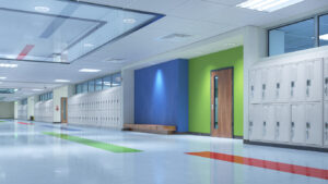 Modern school hallway with energy-efficient LED lighting illuminating lockers and clean walls.